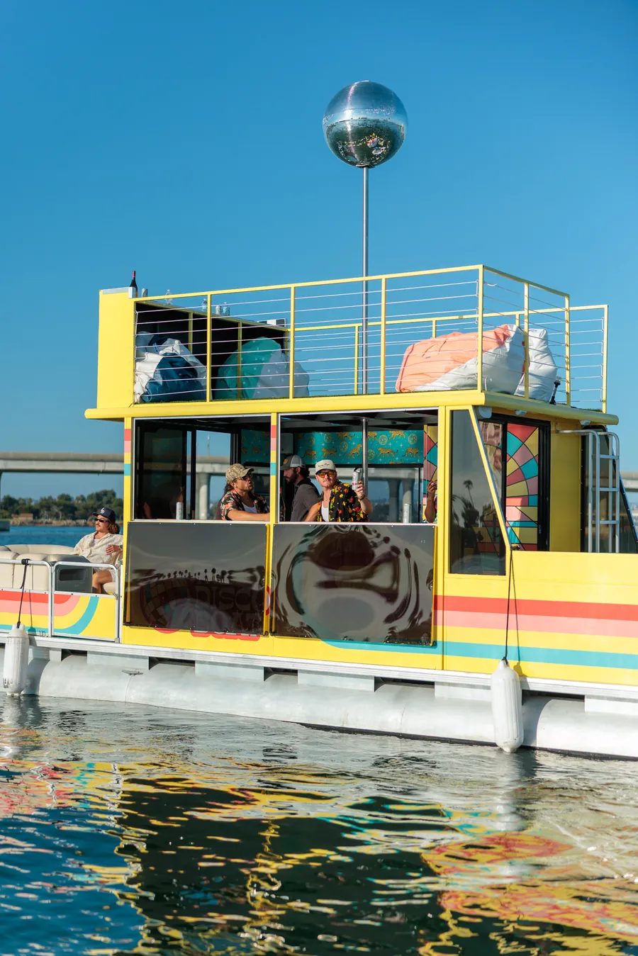 The Disco Boat on San Diego Bay with the fold-down side windows open