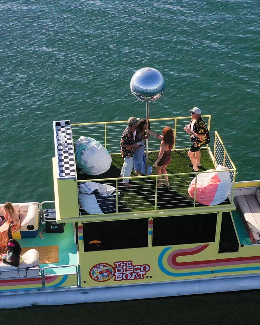 The Disco Boat rooftop deck — open-air lounge above San Diego Bay with the mirrored disco ball